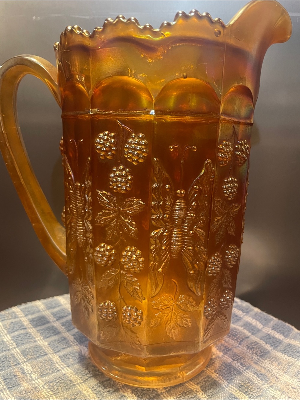 “Butterfly and Berry" marigold carnival glass water pitcher